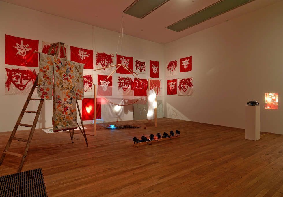 Joan Jonas, The Juniper Tree, 1976/1994, Installation - 24 works on silk, acrylic paint, wooden structure, string of 29 wooden balls, ladder, kimono, mirror, glass jars, 78 slides, box and other materials, Overall display dimensions variable Tate, purchased 2008 Wilkinson Gallery, London, 2008. Photo courtesy Wilkinson Gallery, London, photo by Peter White © 2017 Joan Jonas: Artists Rights Society (ARS), New York : DACS, London.